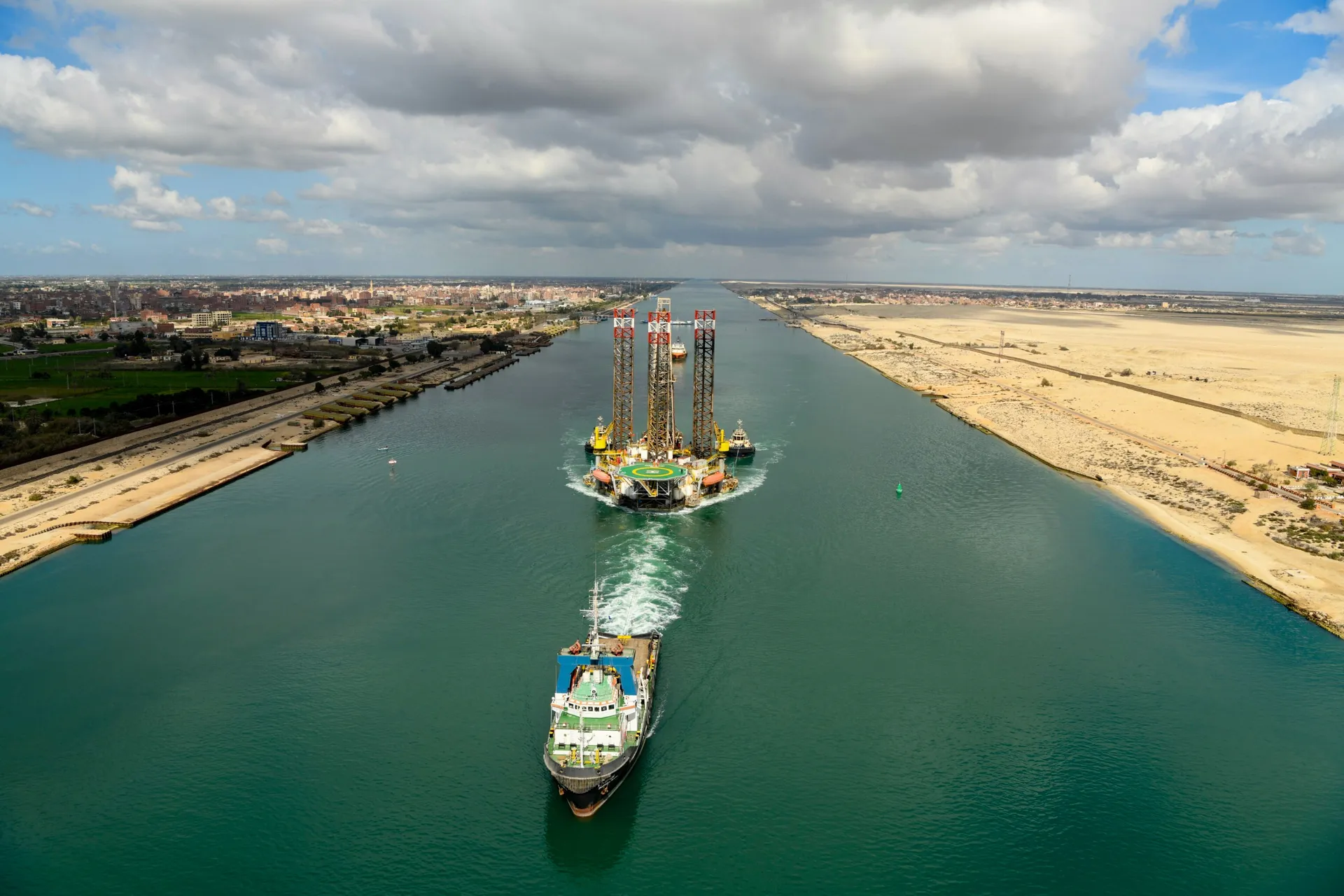 Aerial view of cargo vessels transiting the Suez Canal in convoy